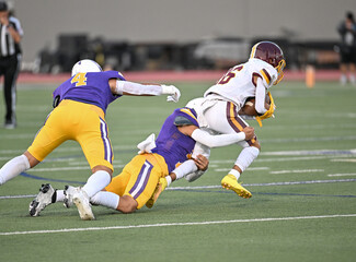 Young athletic tackle football players making great plays during a game