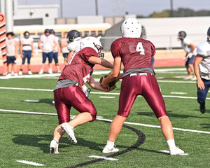 Young athletic tackle football players making great plays during a game