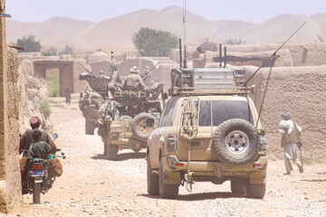 military patrol convoy in the village - obrazy, fototapety, plakaty