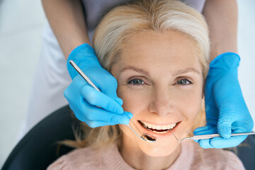 Smiling woman waiting for procedure in dental clinic