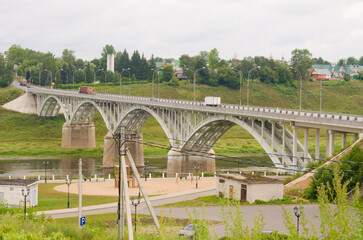 Fototapeta na wymiar Arched road bridge over the Volga in Staritsa, Tver region, Russia