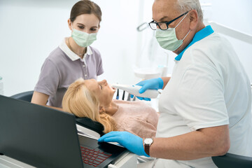 Fototapeta premium Nurse assisting in the examining the woman
