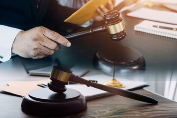 justice and law concept.Male judge in a courtroom on wooden table and Counselor or Male lawyer...