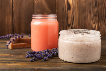 Natural lavender scrub on a brown texture background.Body scrub. Body care. Sugar peeling scrub with argan oil and Himalayan salt. spa set