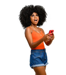 positively surprised young woman points to a white space, holds a smart phone in one hand, black...
