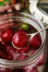 Cherries with sugar in big glass jar