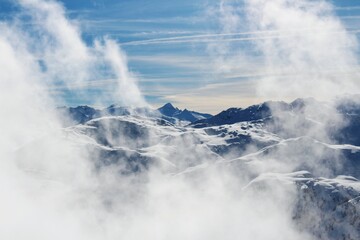 snowy mountains and clouds