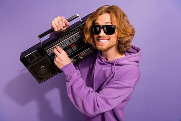 Photo of crazy beard red hair guy listen boombox wear sunglass sweatshirt isolated on purple...