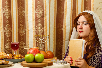 A Jewish woman in a veil falling from her hair after prayer is applied with her forehead to the...