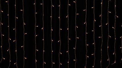 Golden garland lights on black background. New year or Christmas, versatile festive and magical...