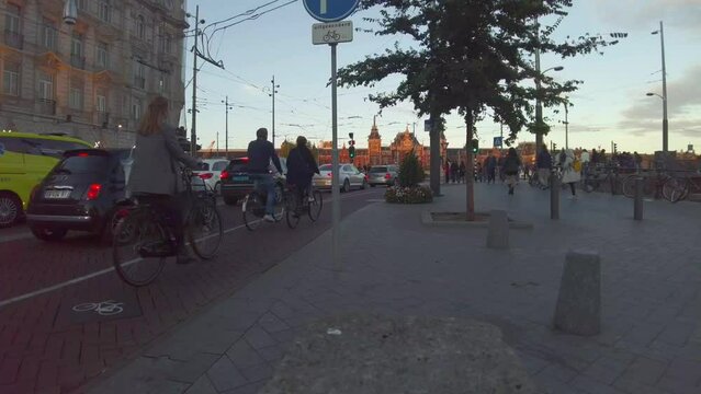 Amsterdam central train station plaza before sunset, time lapse crowded people and traffic jam, wide angle