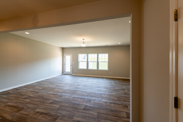 Empty dinning room in a townhouse with ceiling fan, a door, and window.