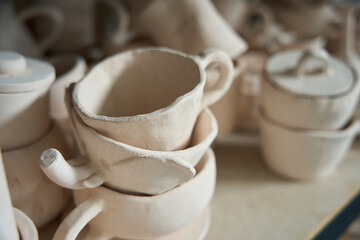 Clay cups and bowls are on the rack
