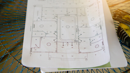 Abstract and construction background of house plan paper laid on the net. and there are blurry...