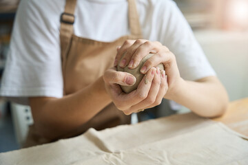 Woman holding a lump of clay in her hands