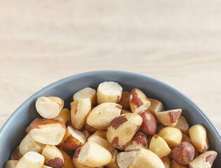 Close up picture of brazil nuts in a bowl, selective focus.