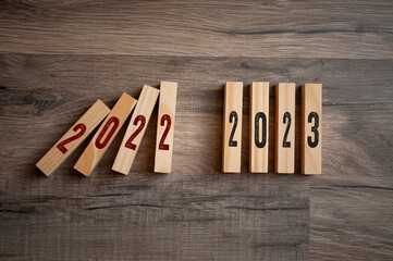 Wooden pieces with 2022 and 2023 on wooden background