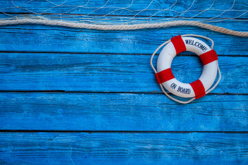 Lifebuoy or life preserver, Maritime Decoration on a blue weathered wood © Stockwerk-Fotodesign