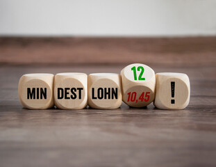 Cubes, dice or blocks with the german word for minimum wage - Mindestlohn on a wooden background