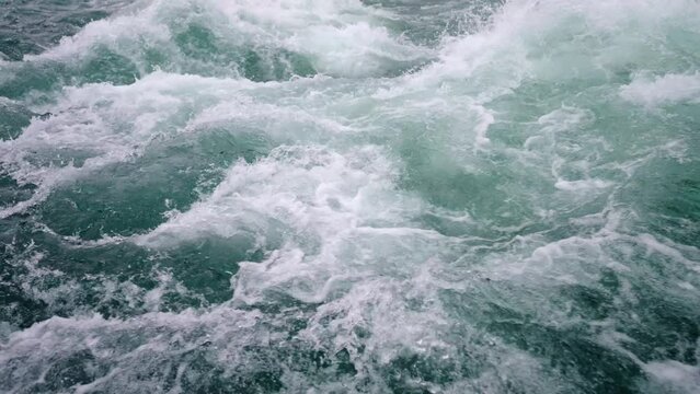 Slow motion of wild clear mountain river , stream flowing through rocks. Close up of river stones with flowing water, clean water flowing in a mountain river Norway