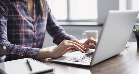 Woman working in office, female hands typing on computer keyboard closeup, businesswoman or student girl using laptop at home, online learning, internet marketing, office workplace, freelance concept