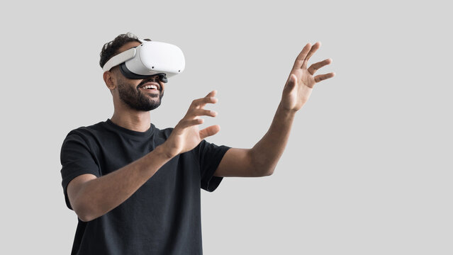 Young man using virtual reality headset isolated on gray background, VR, future gadgets, technology, virtual event, education, study, learning, video game concept