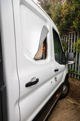 Broken vehicle door lock. Side panel cut with angle grinder.  White van damaged by a thief. Example of rural crime and vehicle crime in the UK.