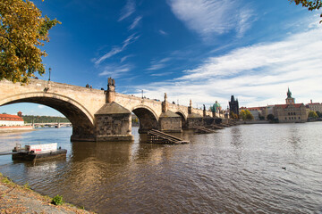 Look over Vltava river to Charles Bridge from embankment in autumn. Prague, Czech Republic.