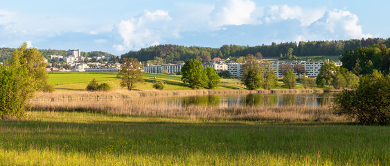 Panoramic view of Affoltern in the suburbs of Zurich by the Katzenseen lakes at golden hour