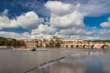Obraz premium Panorama of Prague Castle and Charles bridge in autumn sunny day. Prague, Czech Republic.