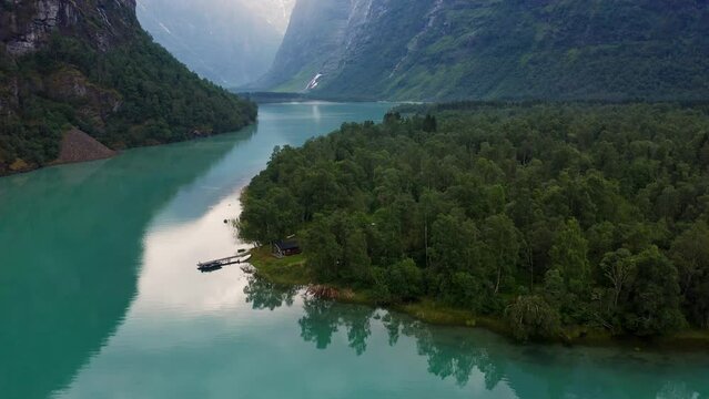 Lake bottom Loenvatnet with glacial river starting to flow dowm Lodalen valley. moving aerial