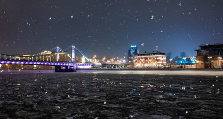 December 14, 2021, Moscow, Russia. The Crimean bridge and ice on the Moscow River during a snowfall on a winter evening.