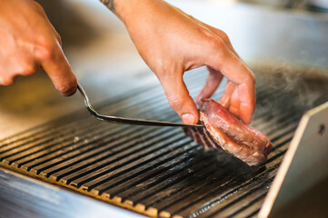 Beef fillet steaks are grilled in strips of bacon, fried steaks with fragrant butter are served. beef fillet, bacon, olive oil, salt, ground black pepper, butter, cheese, parsley, lemon zest, salt