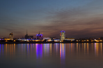 Blagoveshchensk, Russia: view of the Chinese city of Heihe from the embankment of the city of Blagoveshchensk. Lights of the night city in the reflection of the Amur river