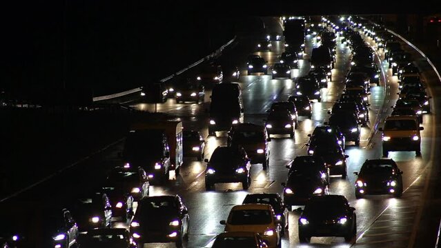 Traffic jam on motorway at night with cars slowly moving, full HD 1080p time lapse footage