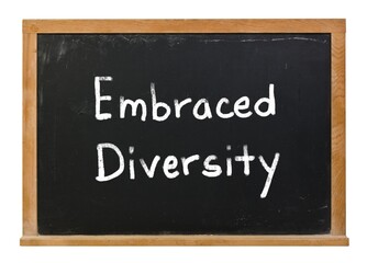 Obraz premium Embraced diversity written in white chalk on a black chalkboard