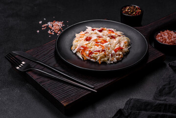 A delicious fresh vegetarian salad of white cabbage, carrot and paprika