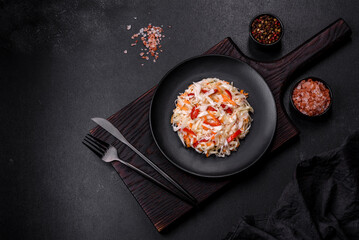 A delicious fresh vegetarian salad of white cabbage, carrot and paprika