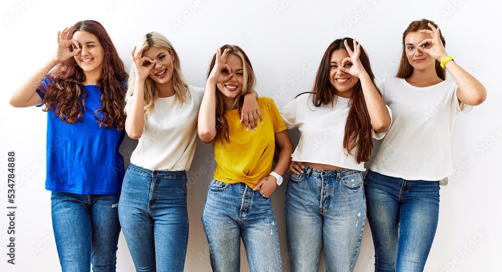 Canvas Prints group of young girl friends standing together over isolated background doing ok gesture with hand sm