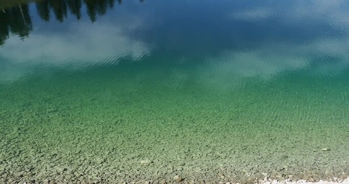 Water. Pure and clear, transparent depth, move aquatic background, greenish yellow waves reflected, surface wriggling and stretching vibrations