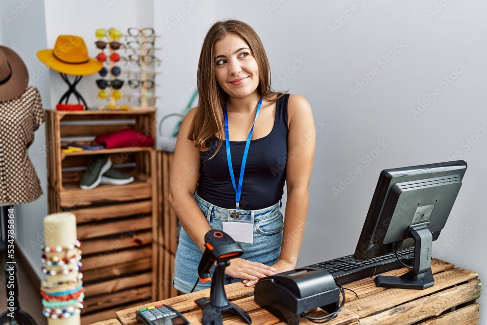 Canvas Prints Young brunette woman holding banner with open text at retail shop smiling looking to the side and staring away thinking.