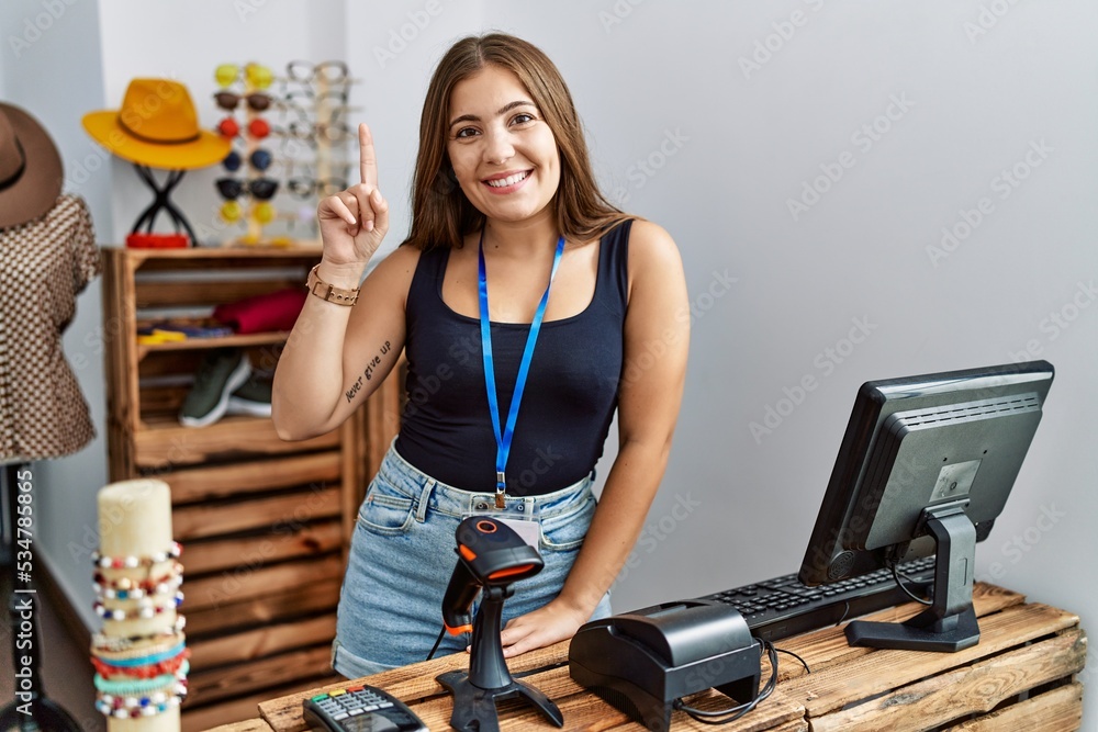 Sticker young brunette woman holding banner with open text at retail shop showing and pointing up with finge