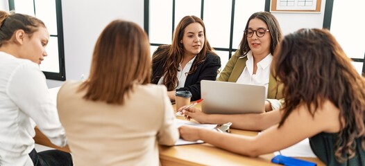 Fototapeta premium Group of young businesswomen smiling happy working at the office.