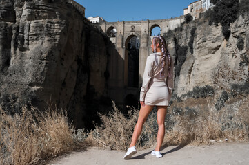 Stylish fashion model posing in summer mini dress. Ronda, Spain.