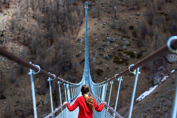 Girl in pigtails walks across the longest suspension bridge in the world - Charles Kuonen...