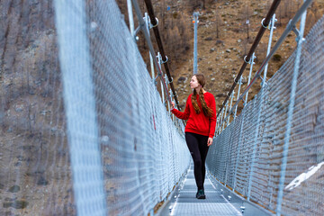 Girl in pigtails walks across the longest suspension bridge in the world - Charles Kuonen...
