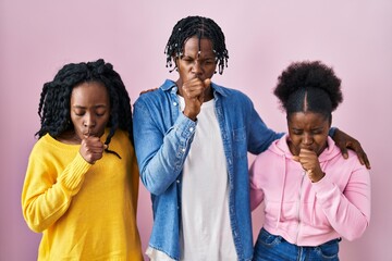 Group of three young black people standing together over pink background feeling unwell and...