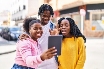 Obraz premium African american friends standing together having video call at street