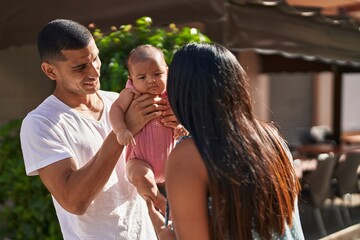 Hispanic family smiling confident hugging each other at street