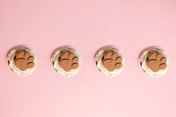 Four appetizing dog muffins on a pink background. In honor of the dog's birthday. High quality photo